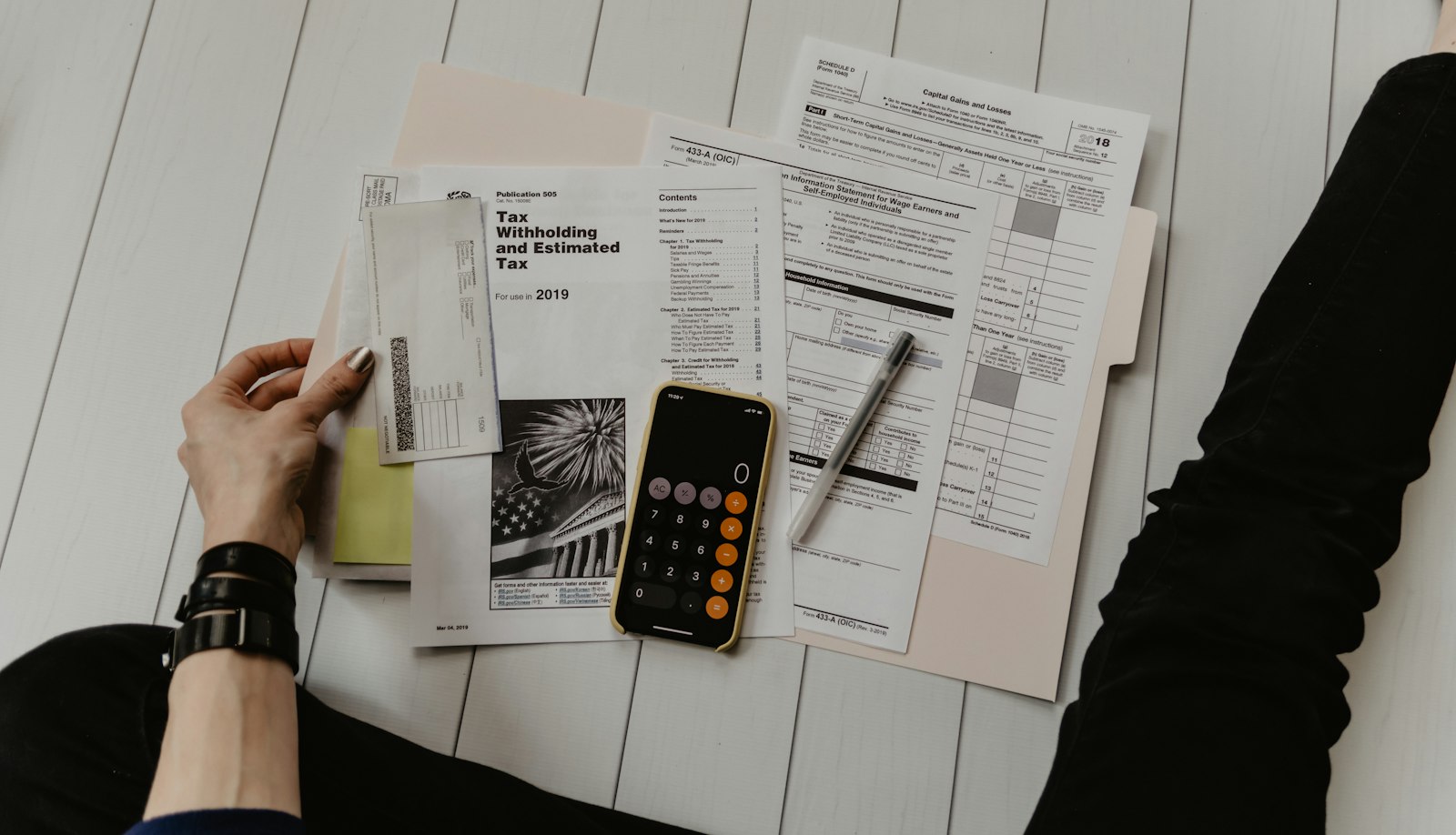 Tax paperwork, a pen and a phone calculator