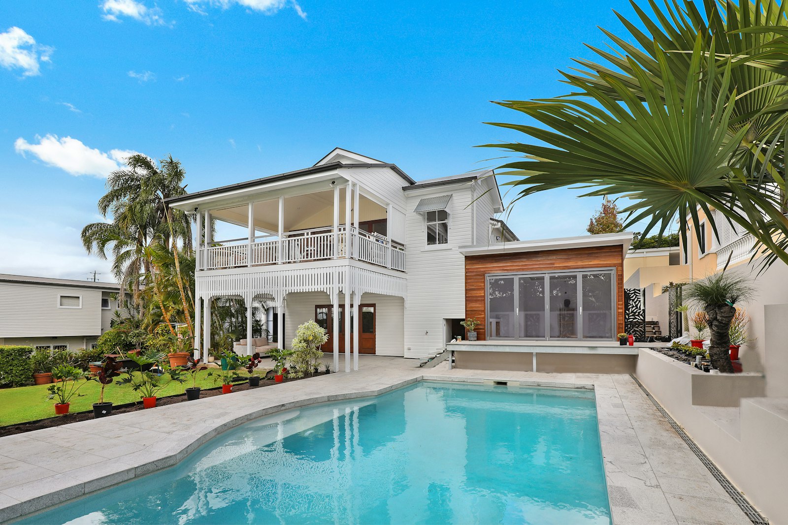 White house with a backyard swimming pool